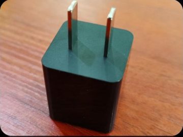 Black cube charger housing with fixed two-pin European plug