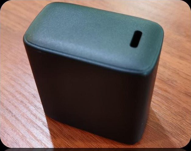 Dark grey cube charger housing with a single recessed slot on the top face