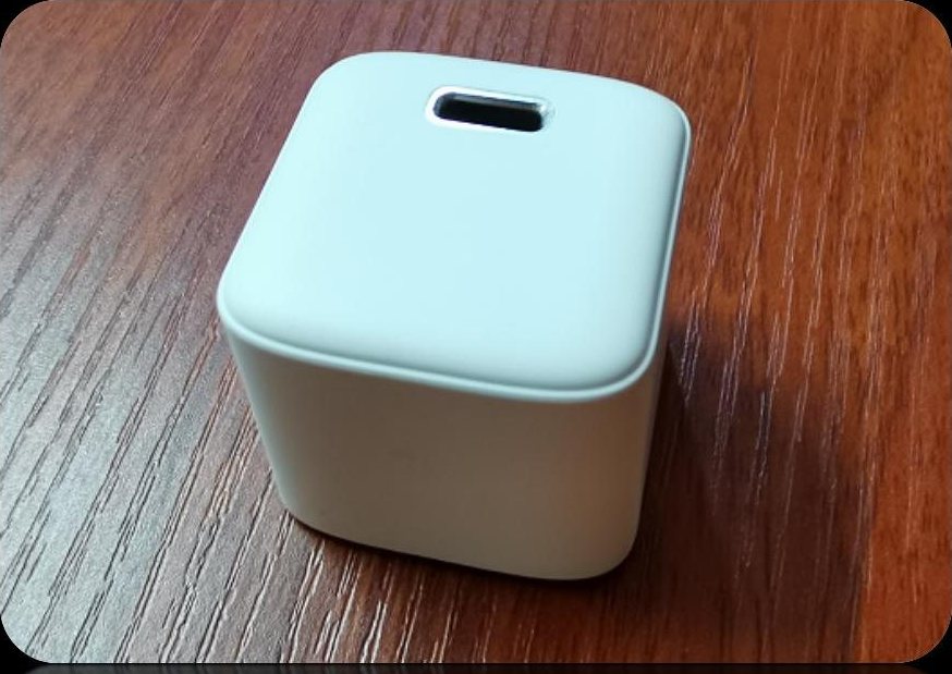White cube PD charger housing with a small oval port window on the top face